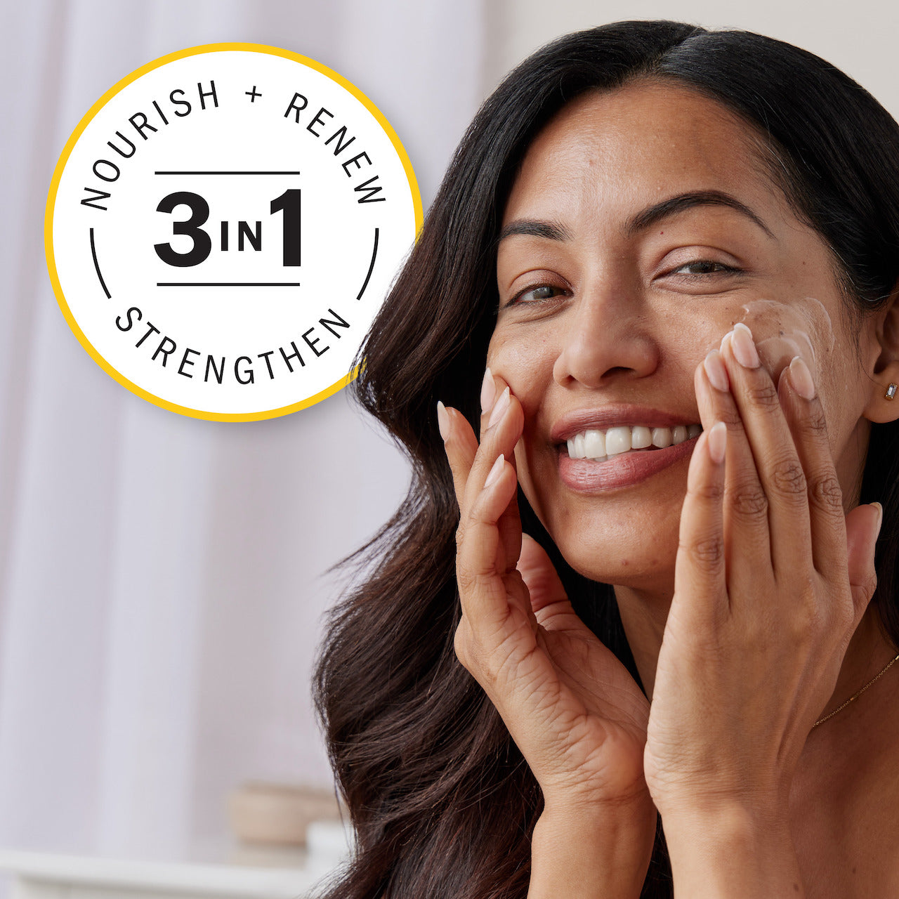 Model applying moisturizer cream to face. 3 in 1 Nourish, renew, strengthen. Model applying moisturizer cream to face. 3 in 1 Nourish, renew, strengthen.