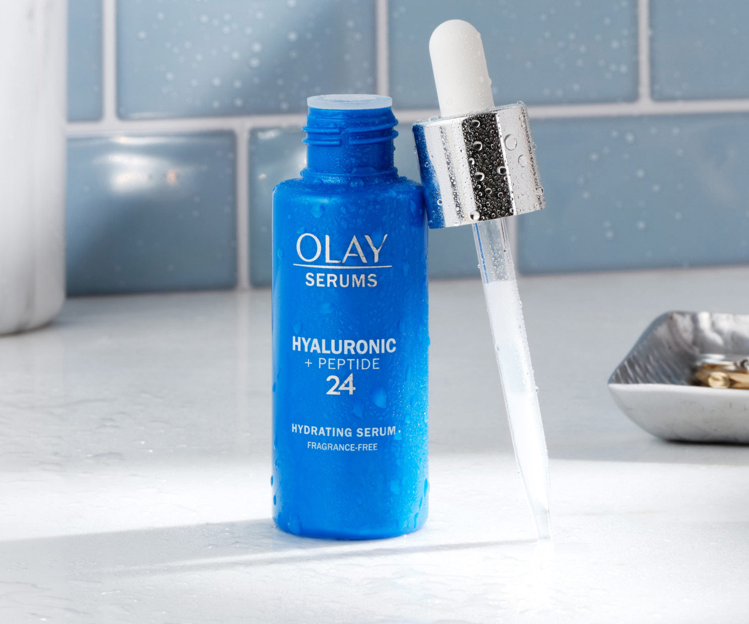 Olay serum bottle with dropper on a bathroom counter Olay serum bottle with dropper on a bathroom counter