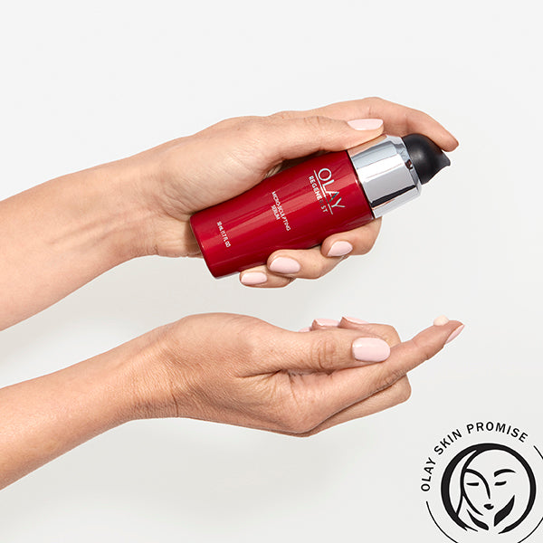 Model holding Micro-Sculpting Serum bottle in hand applying serum to other hand Model holding Micro-Sculpting Serum bottle in hand applying serum to other hand