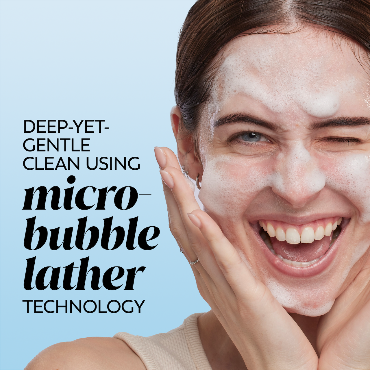 Model posing and smiling while applying melts cleanser to face. Deep yet gentle clean using micro bubble lather technology. Model posing and smiling while applying melts cleanser to face. Deep yet gentle clean using micro bubble lather technology.