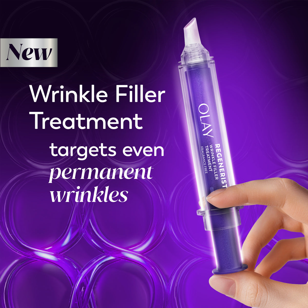 A hand holding a purple Olay Regenerist Wrinkle Filler treatment syringe against a purple background with text advertising wrinkle treatment. A hand holding a purple Olay Regenerist Wrinkle Filler treatment syringe against a purple background with text advertising wrinkle treatment.