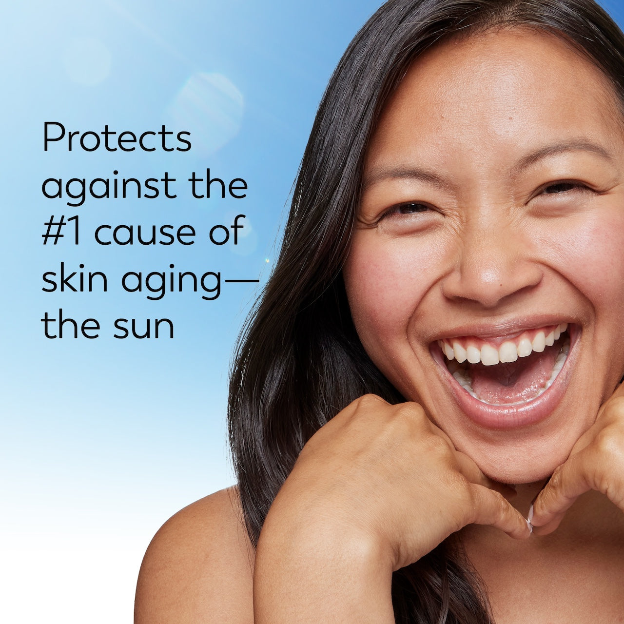 Model posing and smiling. Protects against the #1 cause of skin aging. The sun. Model posing and smiling. Protects against the #1 cause of skin aging. The sun.