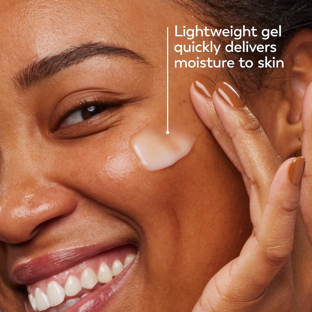 Model posing and smiling applying Olay Hyaluronic Ultralight Gel. Lightweight gel quickly delivers moisture to skin Model posing and smiling applying Olay Hyaluronic Ultralight Gel. Lightweight gel quickly delivers moisture to skin