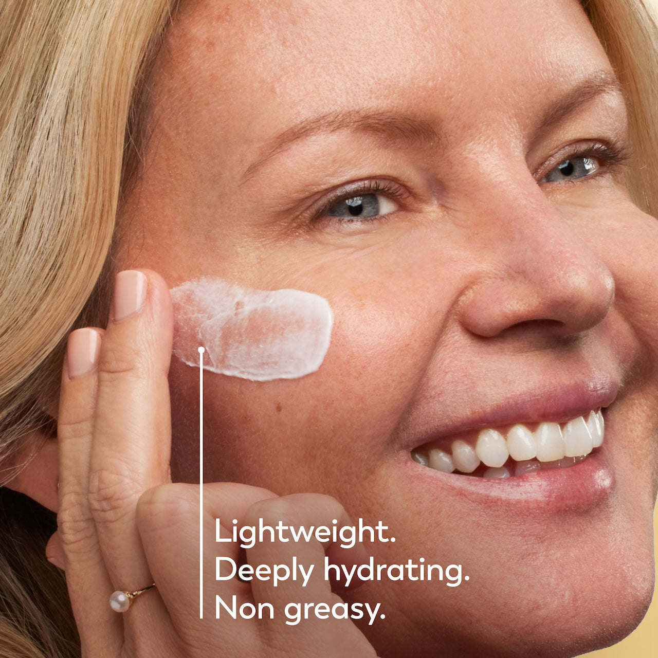 Model posing and smiling applying Collagen Peptide Moisturizing Cream to face. Lightweight. Deeply hydrating. Non greasy. Model posing and smiling applying Collagen Peptide Moisturizing Cream to face. Lightweight. Deeply hydrating. Non greasy.
