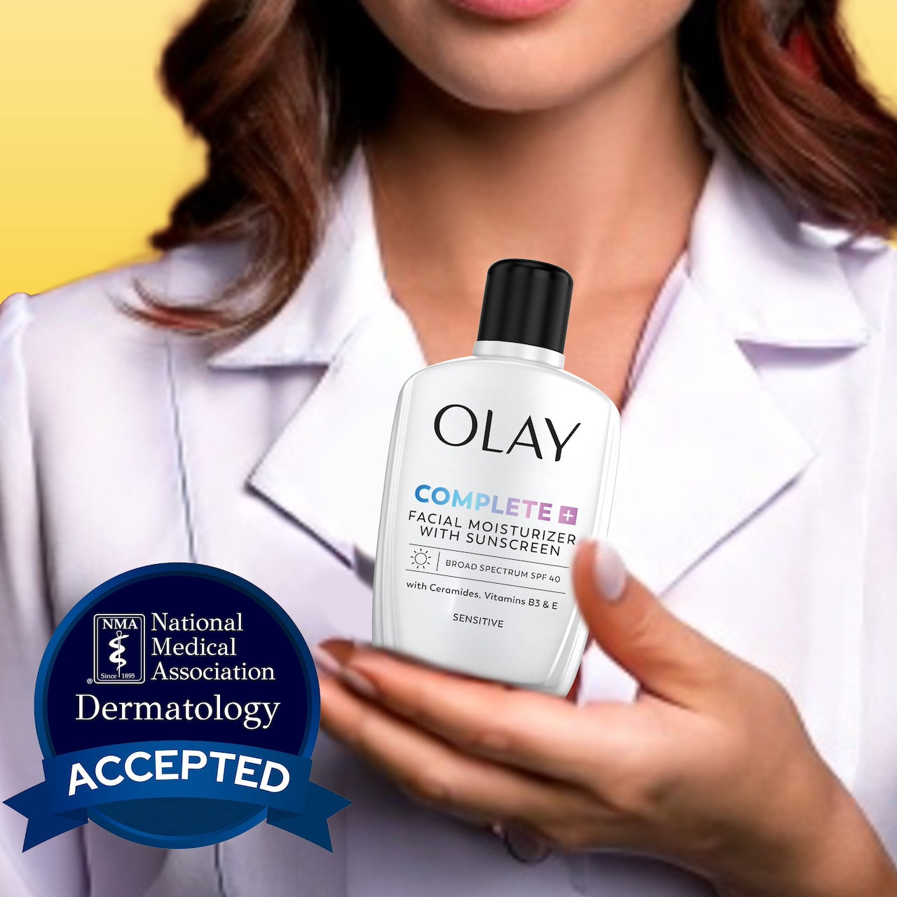 Model holding Olay Complete + Daily Facial Moisturizer with Sunscreen SPF 40 bottle. National medical association dermatology accepted. Model holding Olay Complete + Daily Facial Moisturizer with Sunscreen SPF 40 bottle. National medical association dermatology accepted.