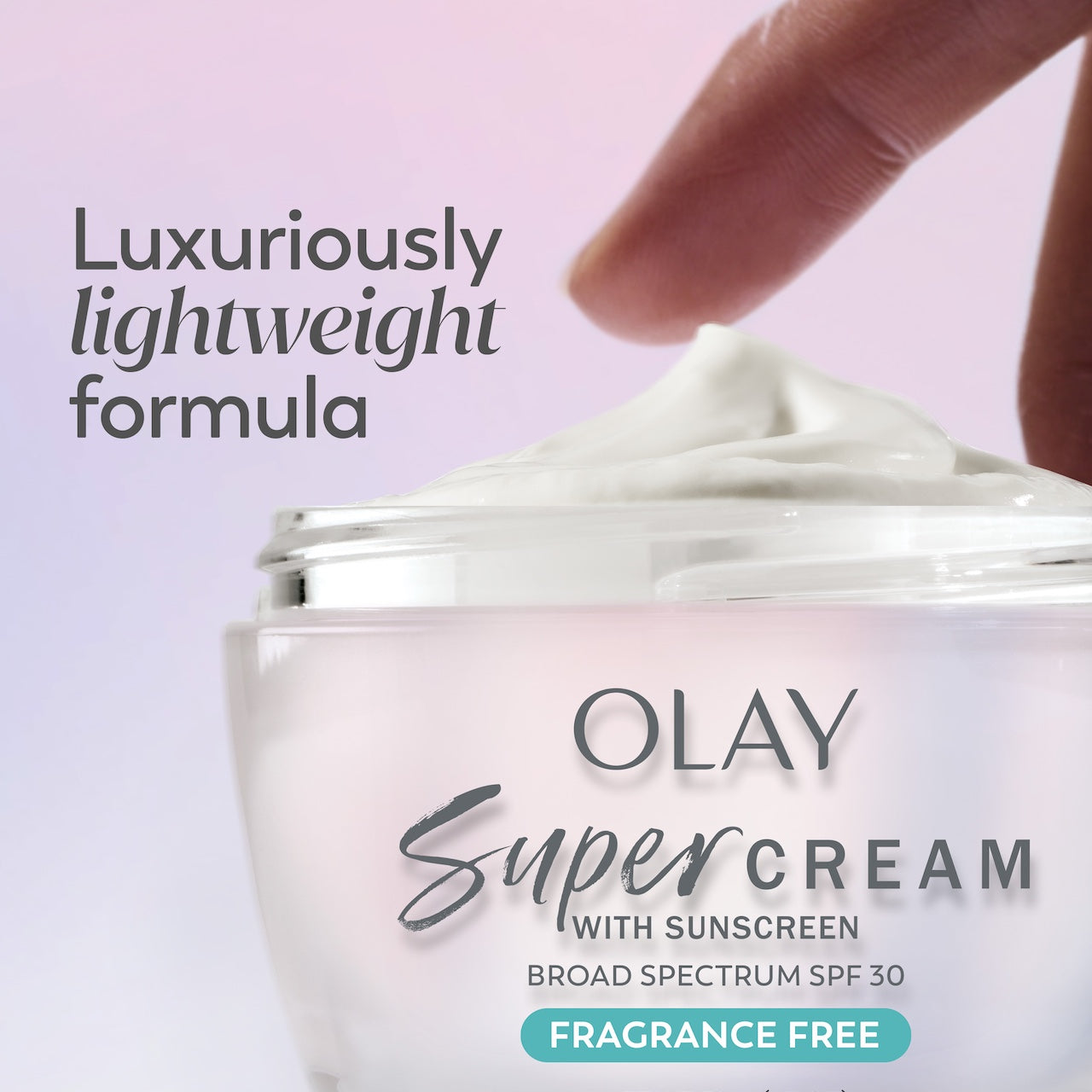 Model dabbing fingers in Olay Super Cream fragrance free. Model dabbing fingers in Olay Super Cream fragrance free.