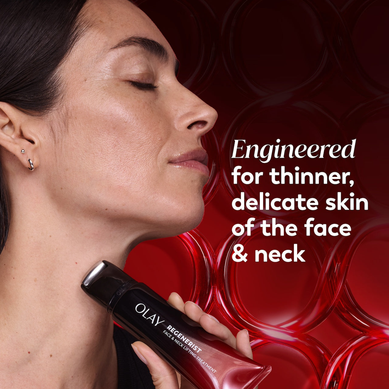 Model posing applying Regenerist Face & Neck Lifting Treatment rolle to neck. Engineered for thinner, delicate skin of the face and neck. Model posing applying Regenerist Face & Neck Lifting Treatment rolle to neck. Engineered for thinner, delicate skin of the face and neck.