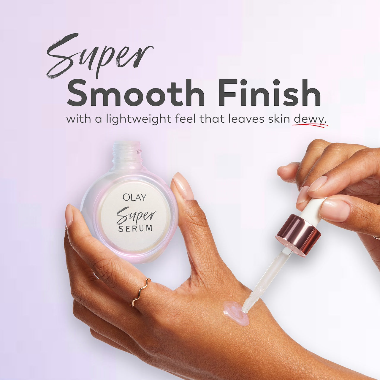 Model applying Super Serum erum to hand with a dropper, while holding the Super Serum jar. Super smooth finish with a lightweight feel that leaves skin dewy Model applying Super Serum erum to hand with a dropper, while holding the Super Serum jar. Super smooth finish with a lightweight feel that leaves skin dewy