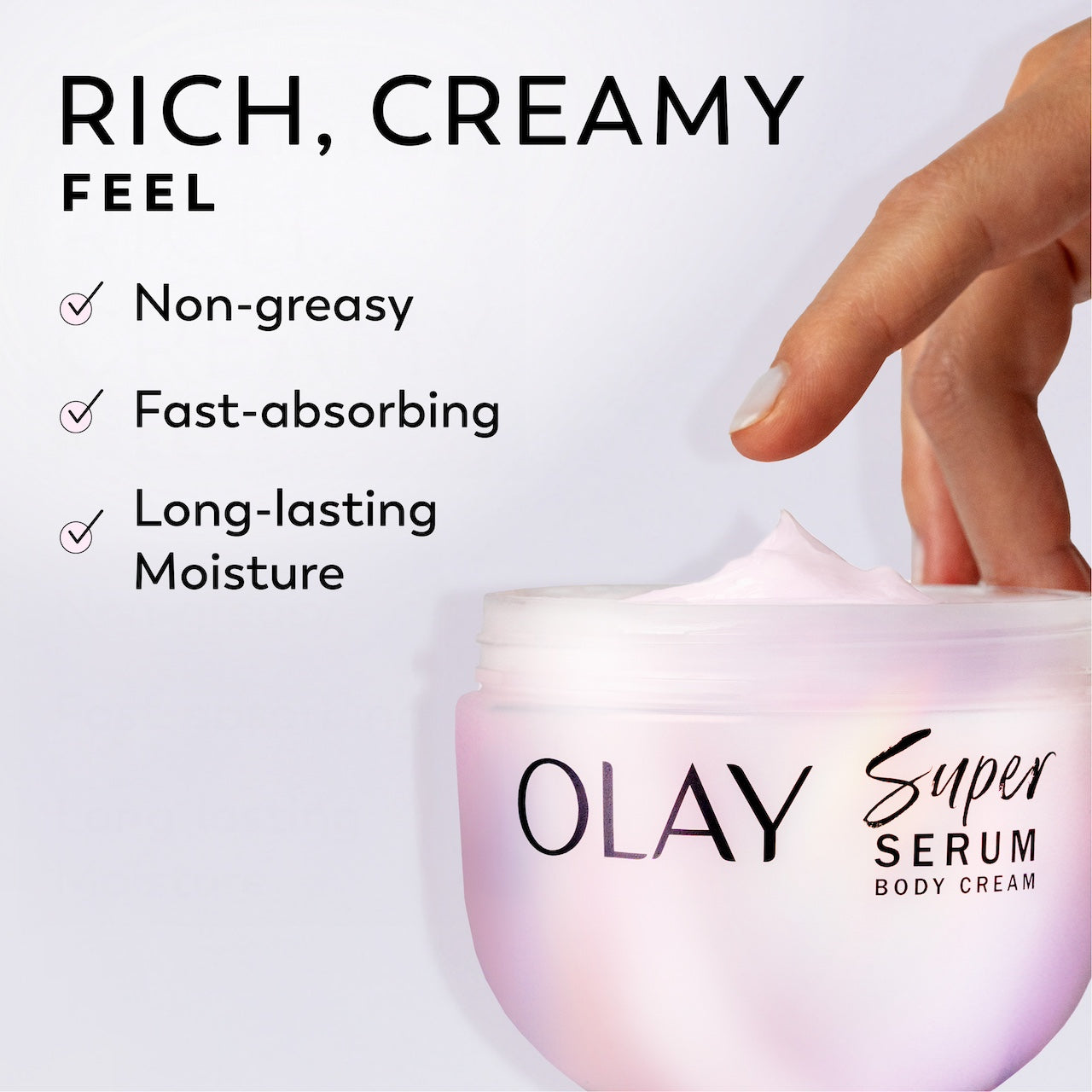 Model dipping fingers in Olay Super Serum Body Cream jar. Rich, creamy feel. Non-greasy, fast absorbing, long lasting moisture Model dipping fingers in Olay Super Serum Body Cream jar. Rich, creamy feel. Non-greasy, fast absorbing, long lasting moisture