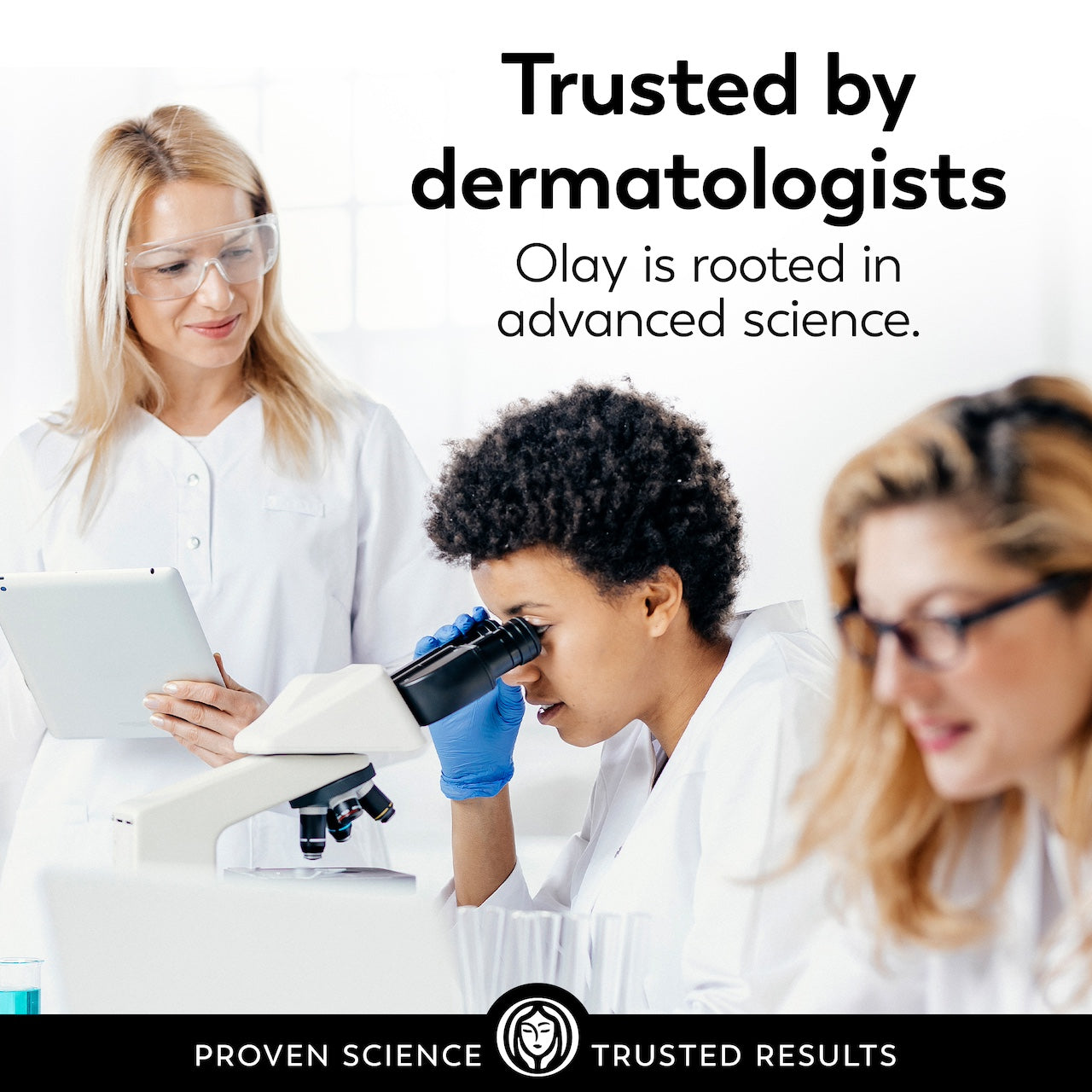 3 scientists observing a microscope. Trusted by dermatologists. Olay is rooted in advanced science.