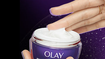A person's hand swiping over Olay Retinol24 Night Moisturizer cream.