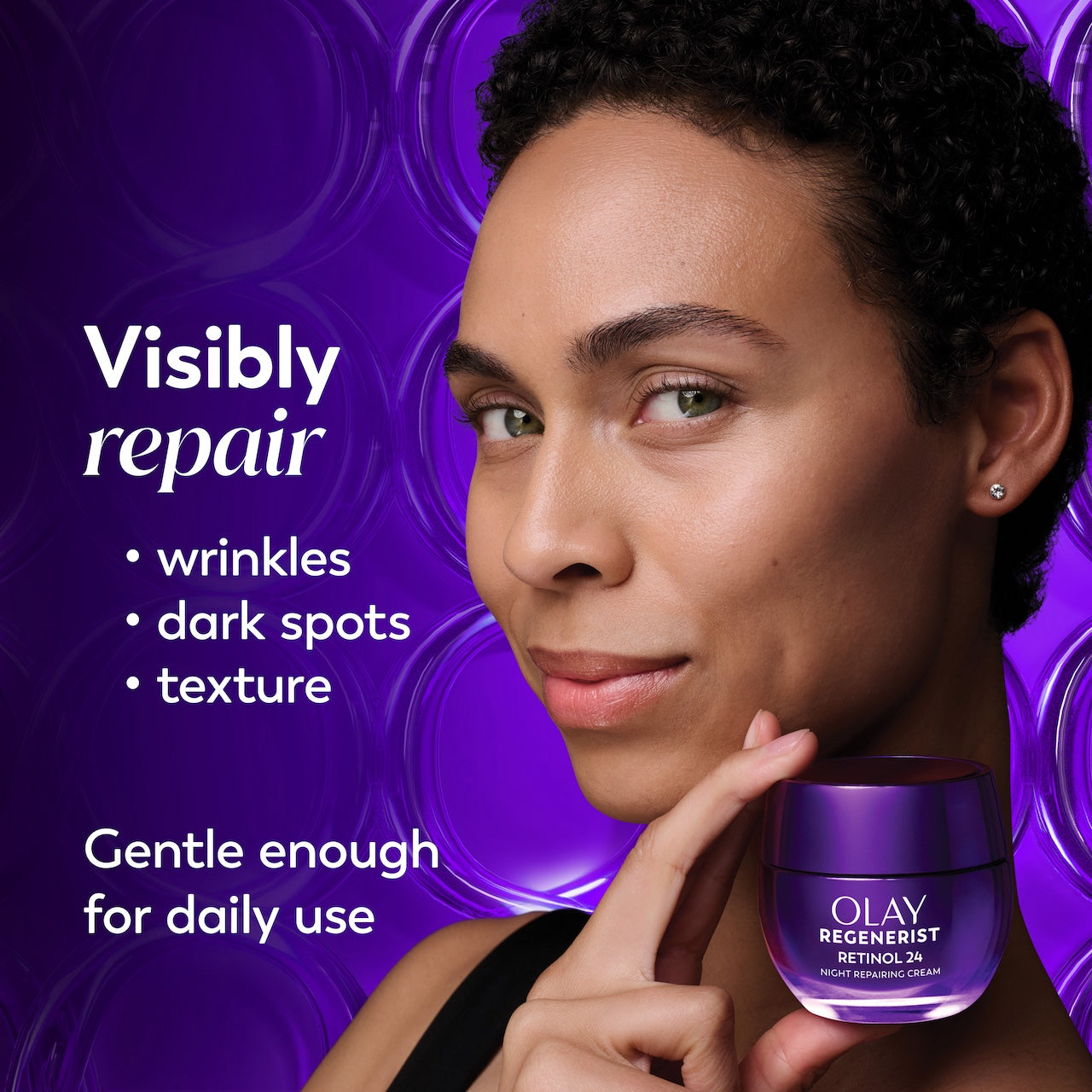Model posing holding Olay Retinol24 Night Moisturizer jar. Visibly repair wrinkles, dark spots, texture. Gentle enough for daily use