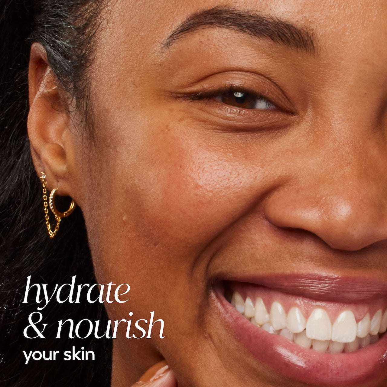 Model posing and smiling. Hydrate and nourish your skin.
