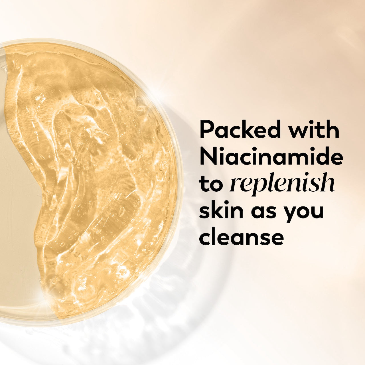 Skincare product with gold texture on a beige background, labeled with niacinamide benefits.