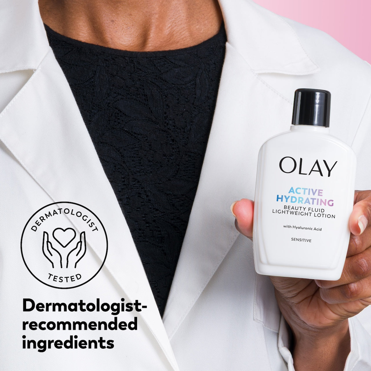 Person holding an Olay Active Hydrating Beauty Fluid with a dermatologist-tested logo.