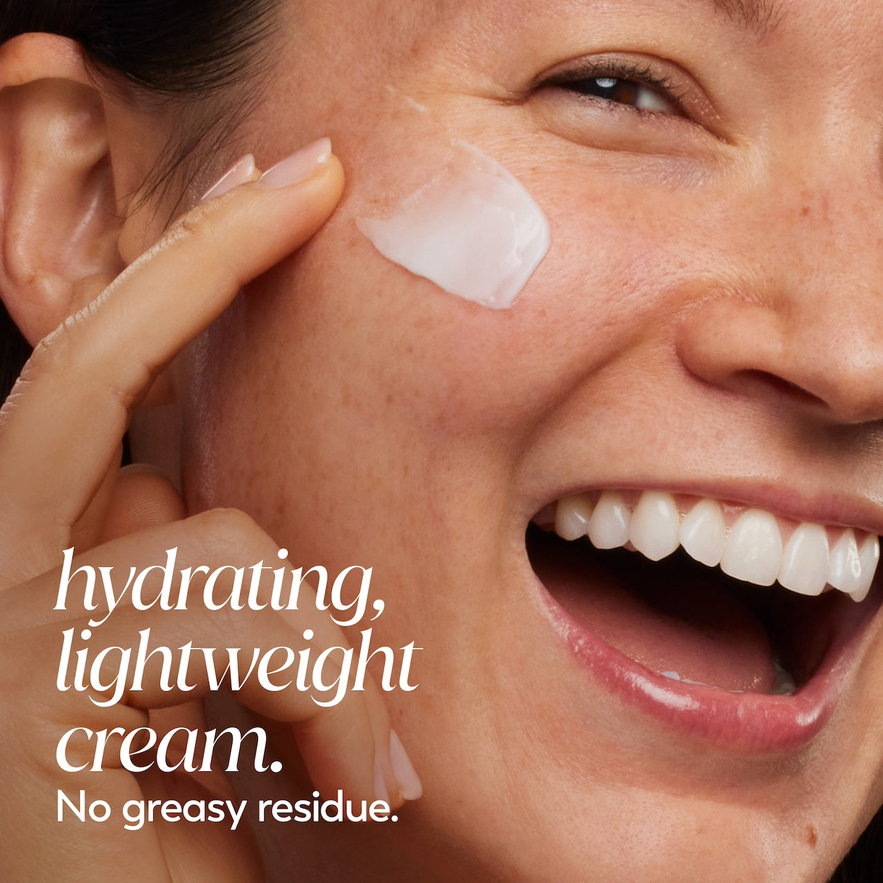 Model posing, smiling applying Olay Retinol 24 MAX Night Moisturizer cream to face. Hydrating, lightweight cream. No greasy residue.