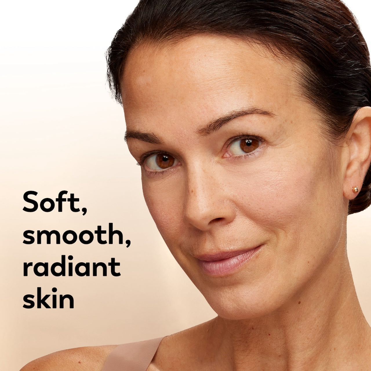 Woman with soft, smooth, radiant skin on a beige background