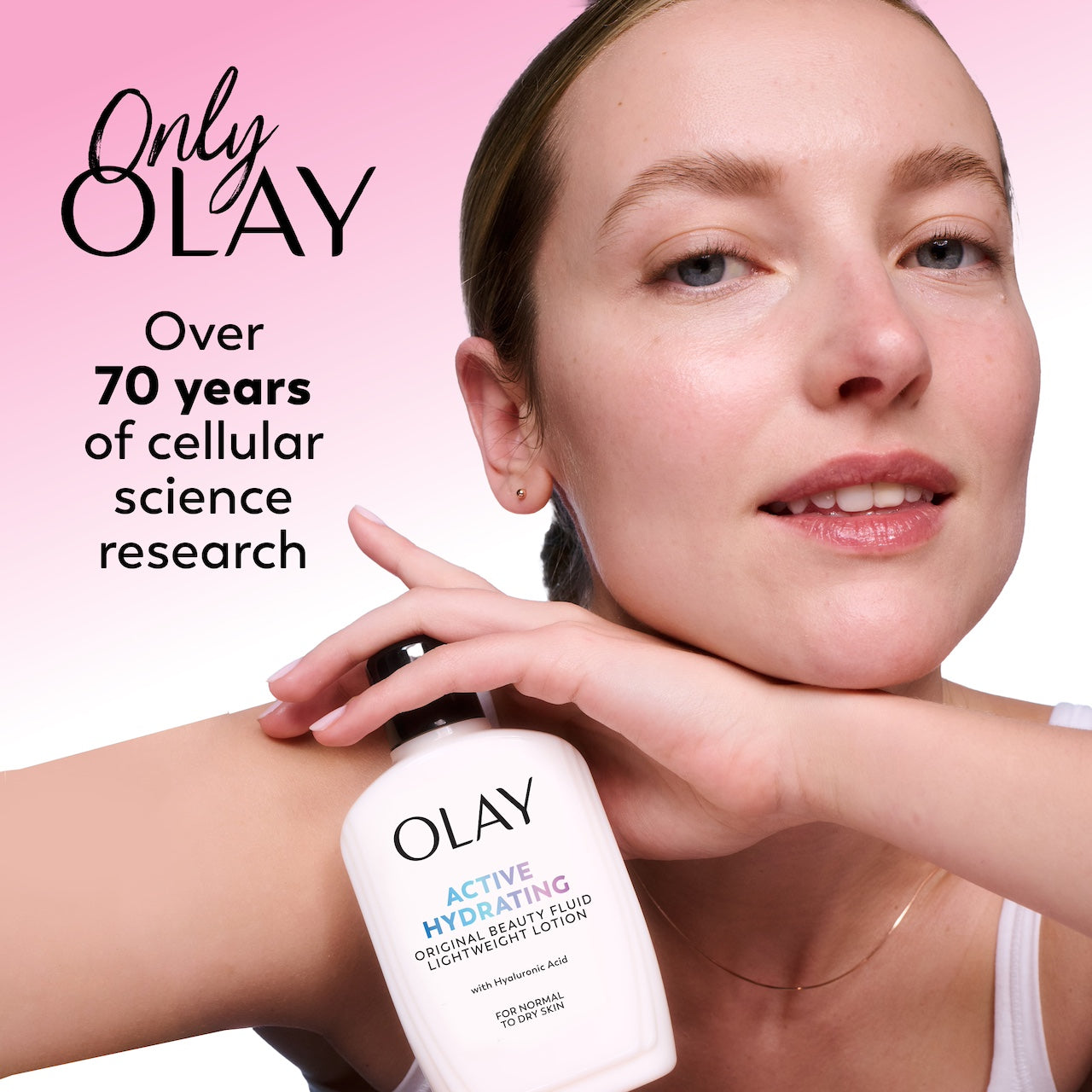 Woman applying Olay Active Hydrating cream with pink background and Olay branding.