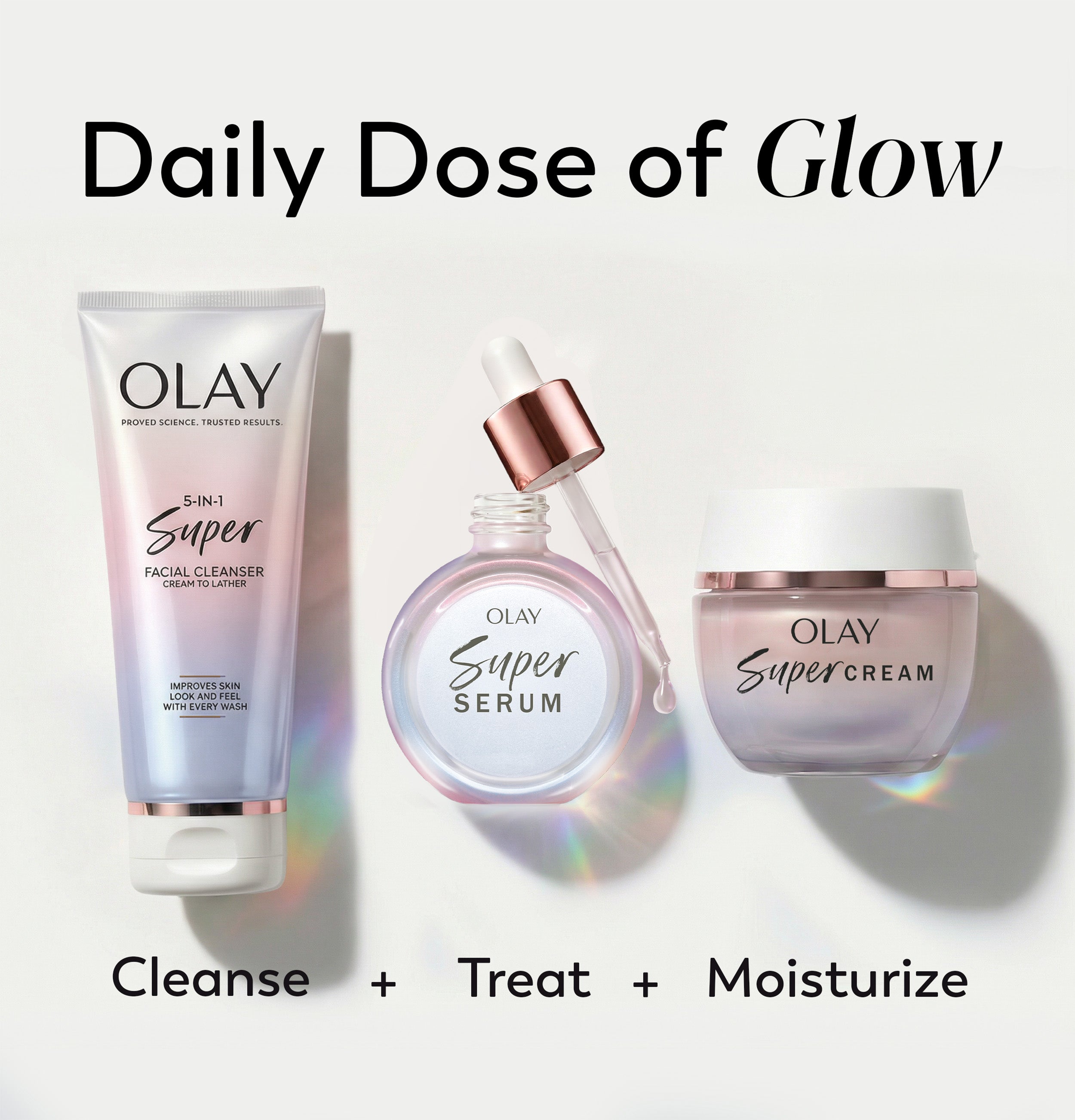 Three Olay skincare products arranged on a light gray background with the headline 'Daily Dose of Glow' at the top and 'Cleanse + Treat + Moisturize' at the bottom. The products are a tube of Olay Super Facial Cleanser, a round dropper bottle of Olay Super Serum with rose-gold accents, and a jar of Olay Super Cream.