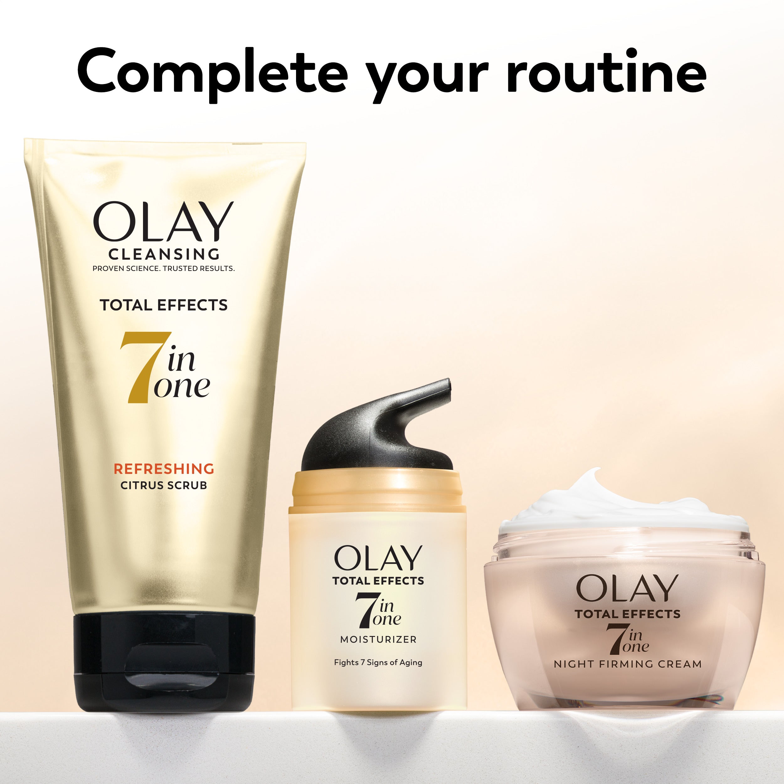 Olay skincare products including a scrub, moisturizer, and night firming cream on a beige background.