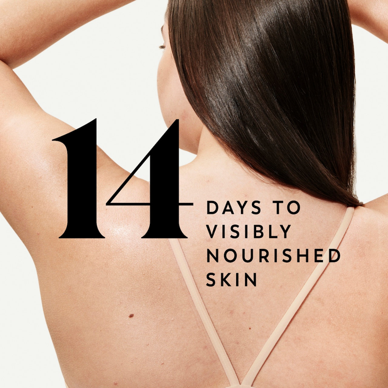 Model posing back facing showing nourished skin. 14 days to visibly nourished skin
