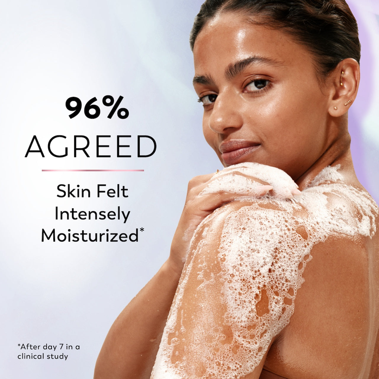 Model posing lathering body wash on skin. 96% agreed skin felt intensely moisturized*. *after day 7 in a clinical study