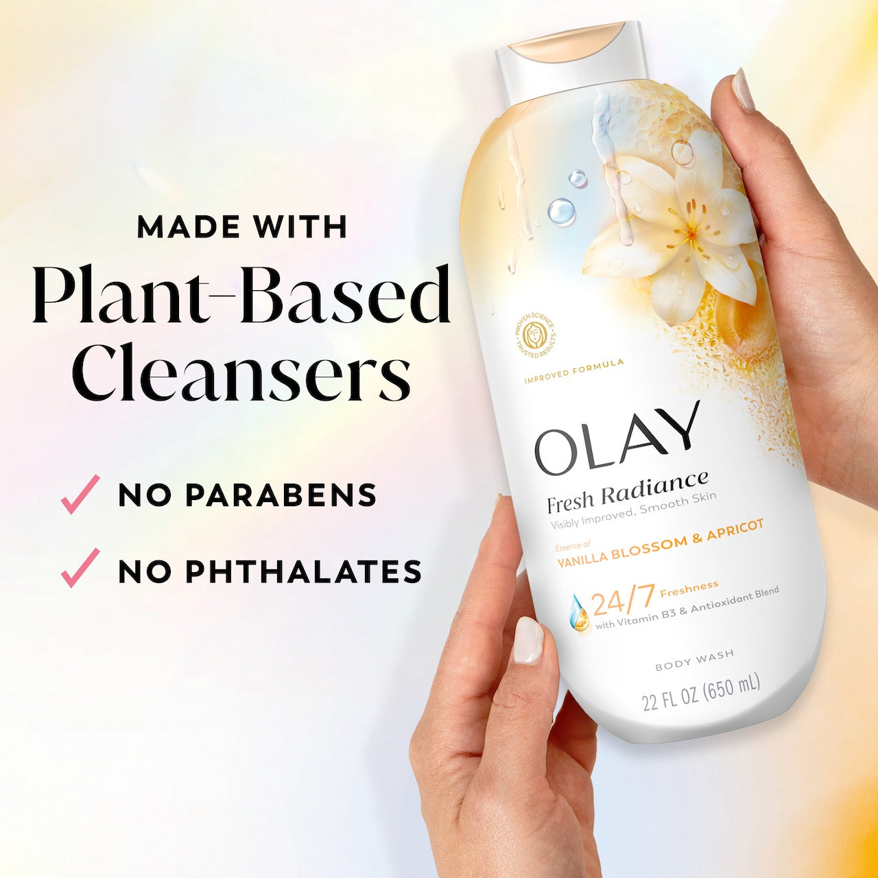 Model holding Fresh Radiance Body Wash bottle. Made with plant based cleansers. No parabens, no phthalates
