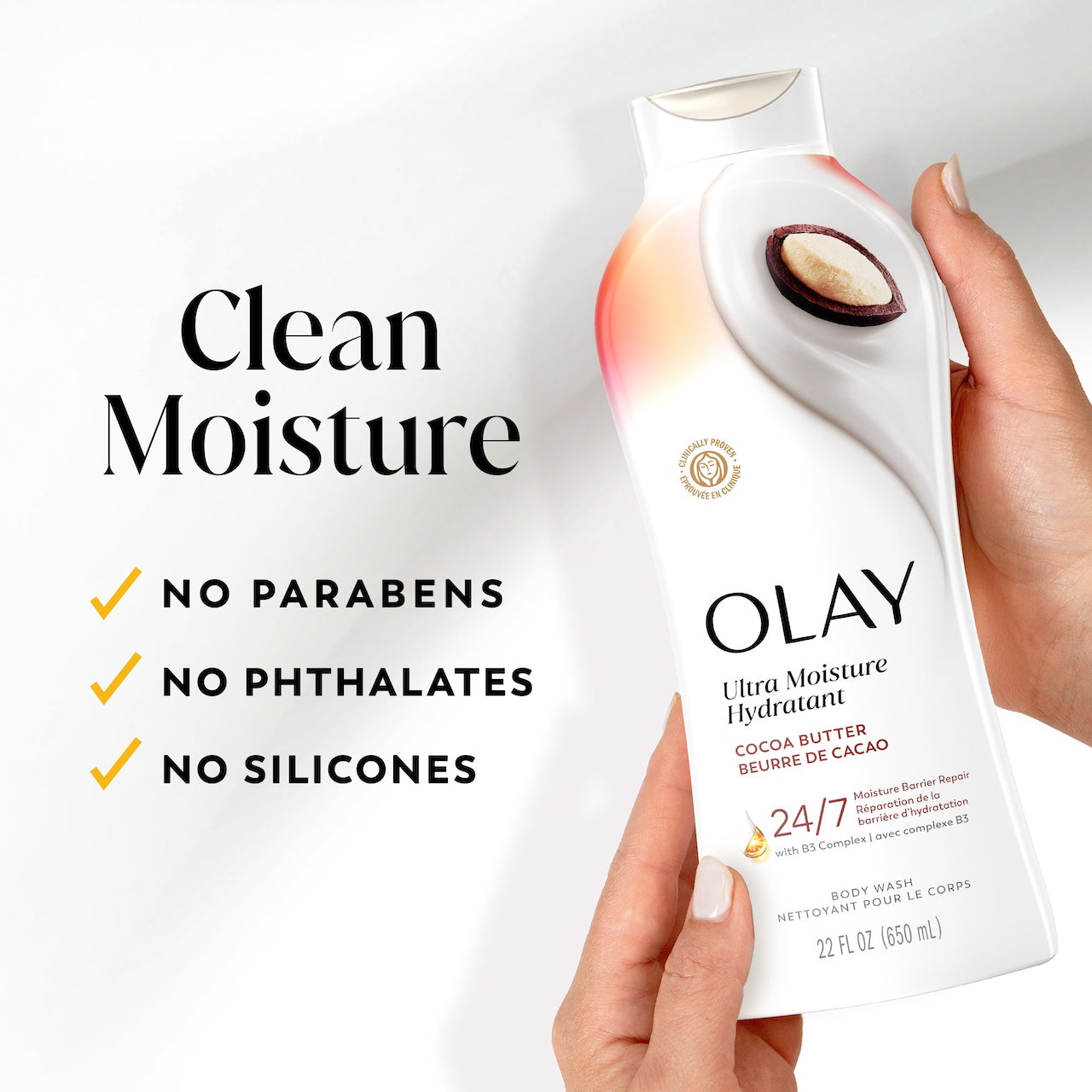 Model holding Olay Ultra Moisture Body Wash. Clean moisture. No prarbens, no phthalates, no silicones