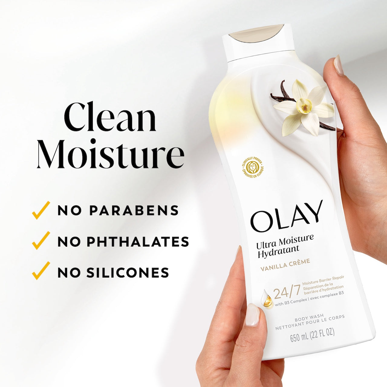 Model holding Olay Ultra Moisture Body Wash Vanilla Creme. Clean moisture, no parabens, no phthalates, no silicones