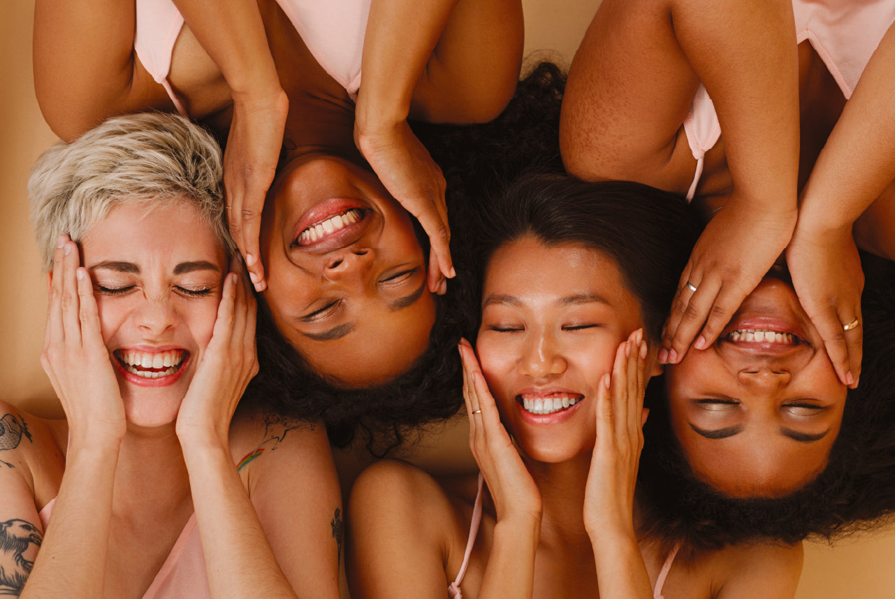  Two African American females smiling with their faces beside each other