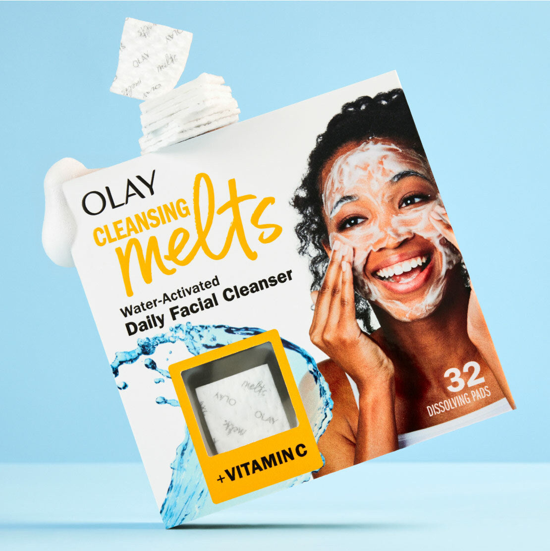 Olay Cleansing Melts packaging with a woman applying product on a blue background