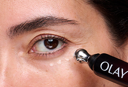 Person applying eye cream serum treatment