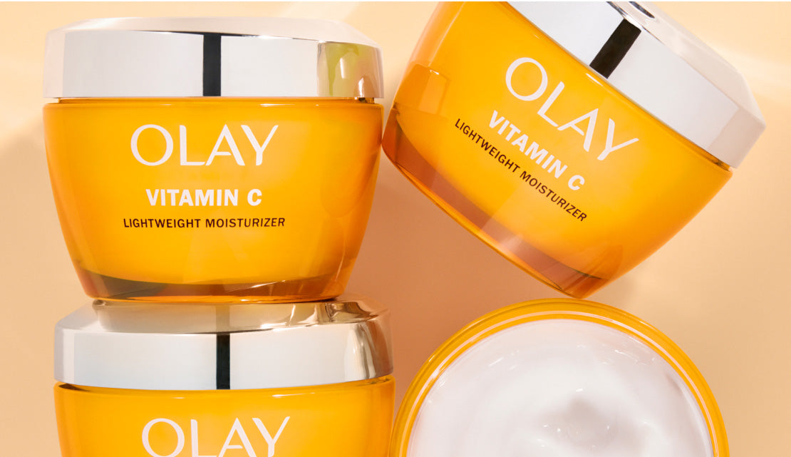 Three Olay Vitamin C moisturizers on a beige background